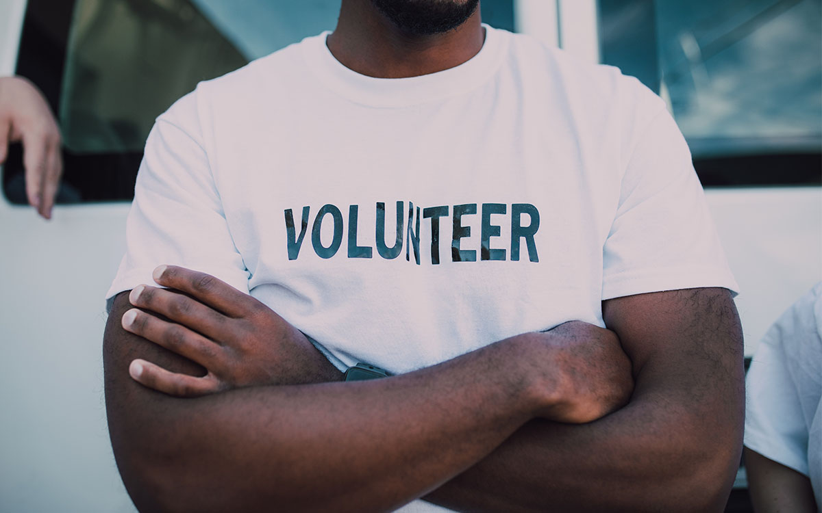 Picture of a volunteer with his arms crossed for blog on observing National Nonprofit Day