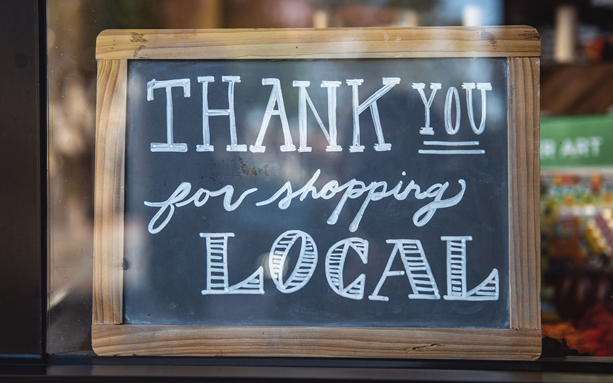 Chalkboard sign that reads thank you for shopping local