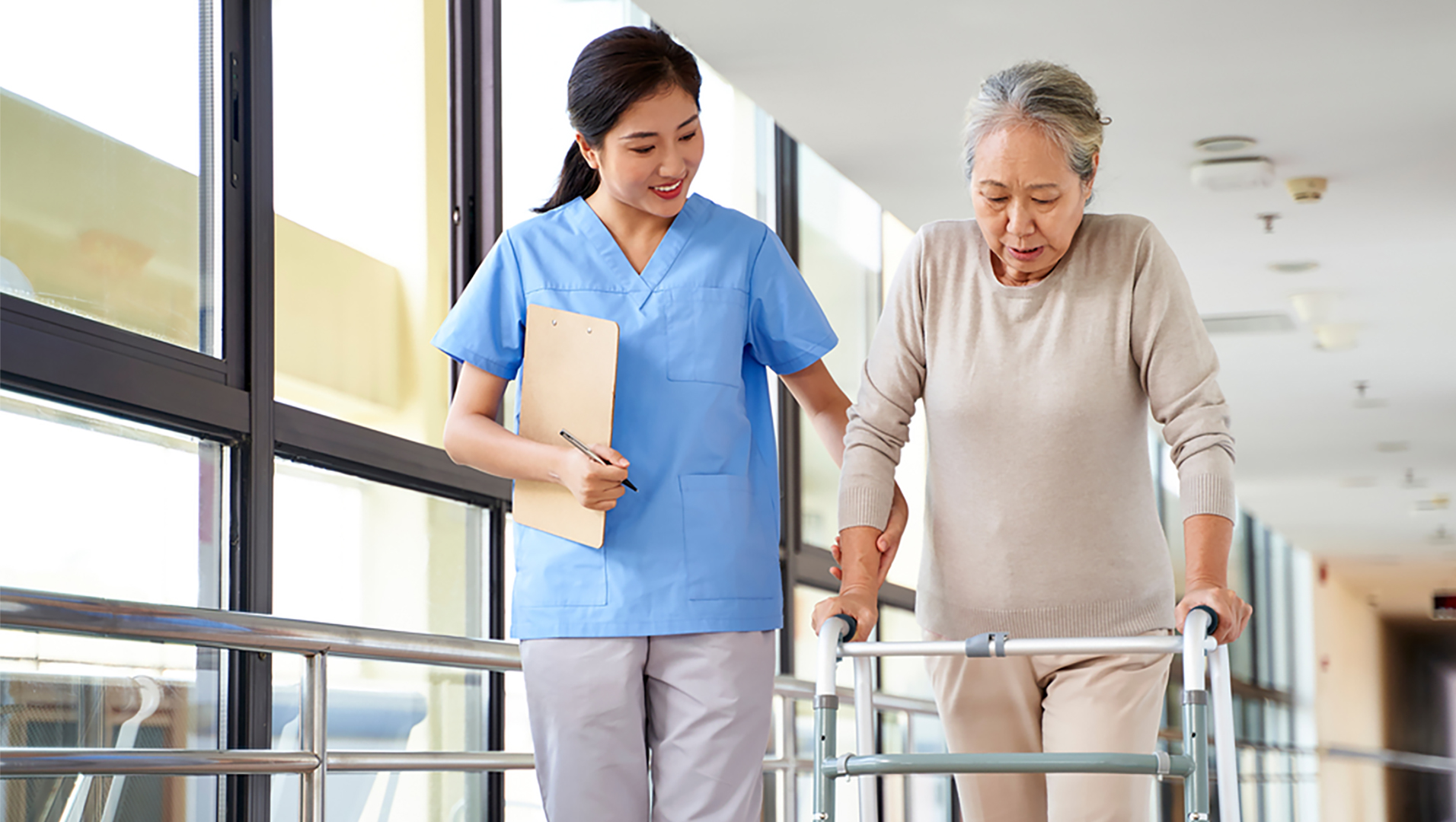 A nurse walks with an elderly patient