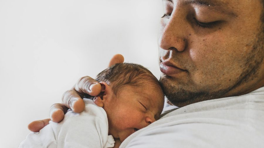 father caring for newborn baby